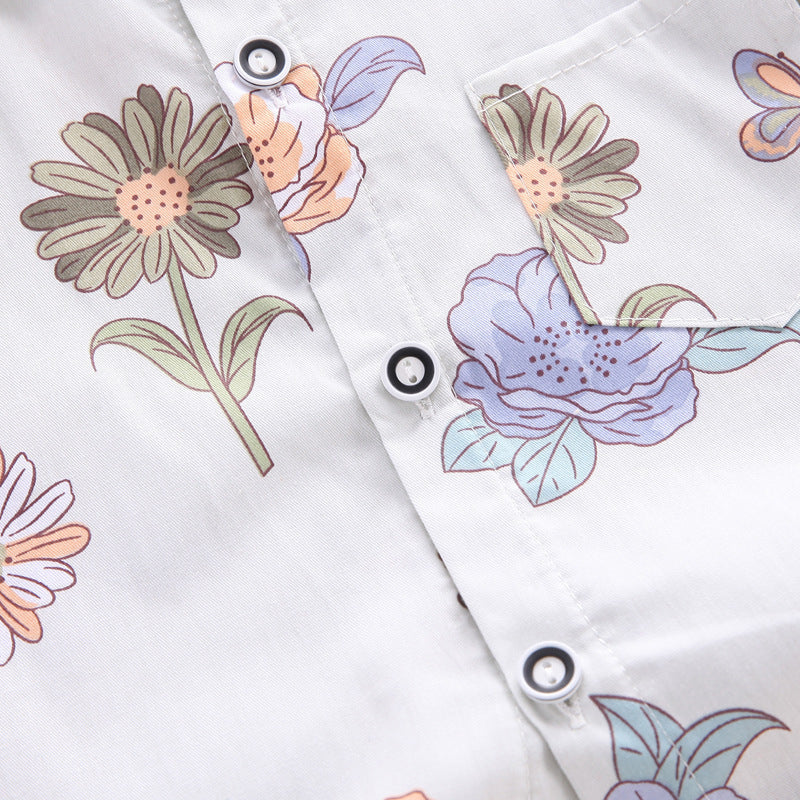 Boys' floral print shirt and coordinating shorts from Ju Ju Jam, offering a bright and stylish summer outfit.