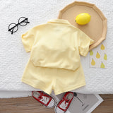 Pastel-colored baby girl outfit by Ju Ju Jam, including a co-ord set with a top and pants adorned with 3D flower embellishments.