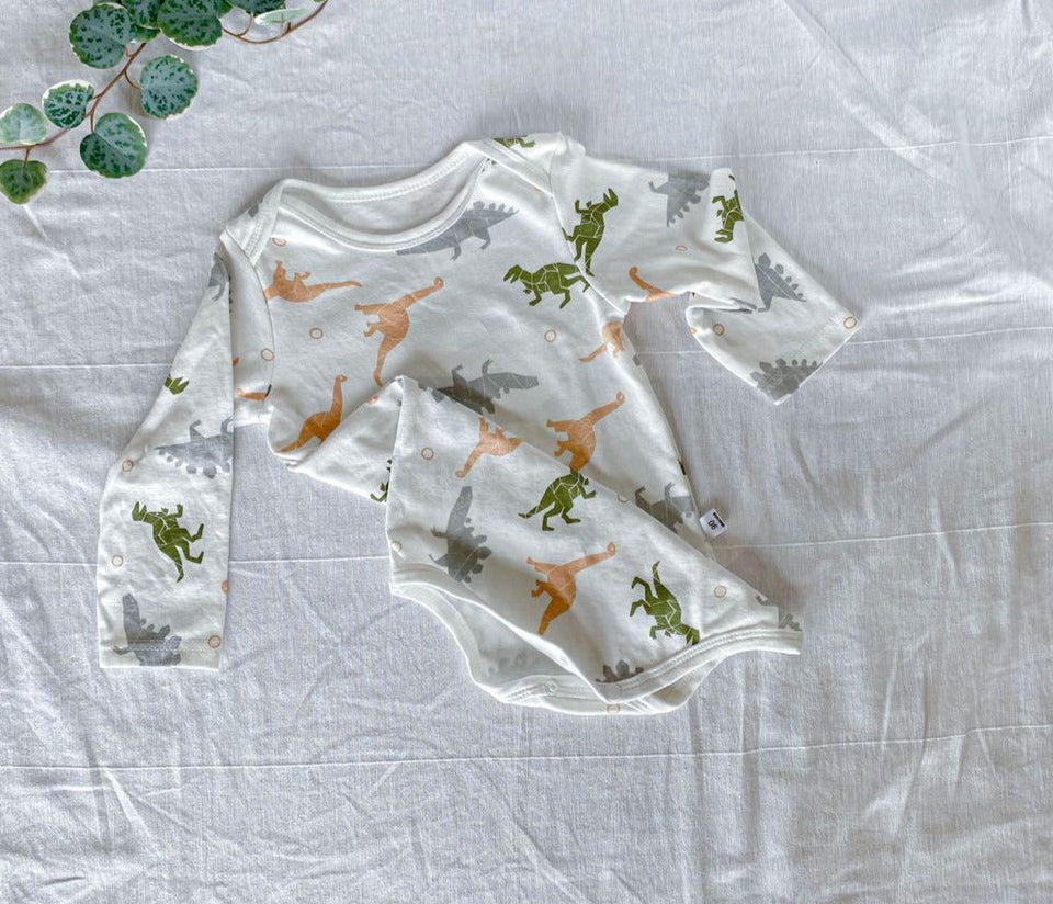 Cute baby in a dinosaur-themed romper from Ju Ju Jam
