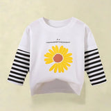 Happy Day Sunflower Top from Ju Ju Jam displayed on a hanger, emphasizing its vibrant sunflower motif for girls.