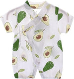 Infant dressed in a playful avocado print romper from Ju Ju Jam.