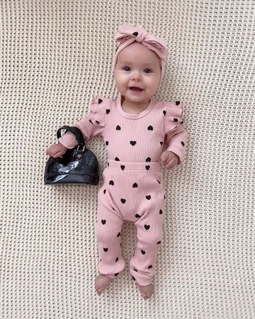 Stylish baby girls romper and pant set with ruffle sleeves and head bow from Ju Ju Jam – perfect for a charming, coordinated outfit