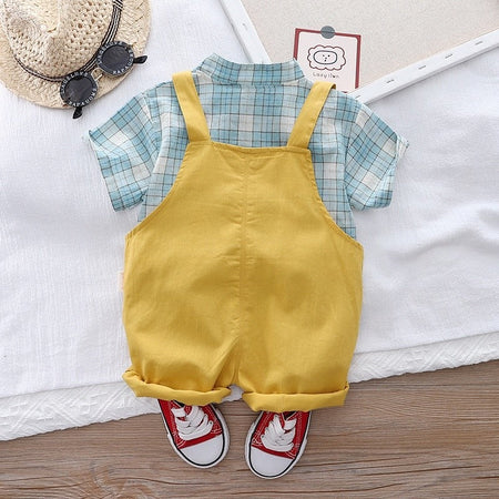 Charming baby boy in a Checkered Bear Pocket jumpsuit, showcasing a playful bear design from Ju Ju Jam.