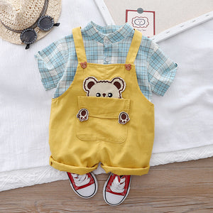 Infant dressed in a Checkered Bear Pocket jumpsuit, perfect for a stylish and playful look from Ju Ju Jam.