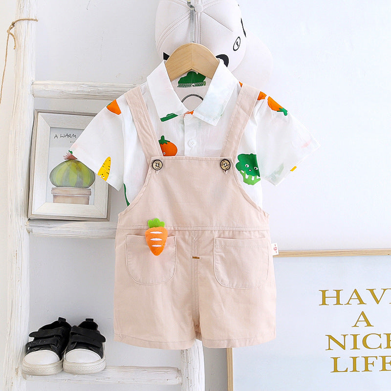 Baby boy in a Happy Veggies jumpsuit featuring cheerful vegetable prints from Ju Ju Jam.