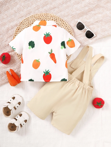 Adorable baby wearing a Happy Veggies jumpsuit, designed with fun vegetable illustrations from Ju Ju Jam."