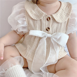 Infant dressed in a cute My Lady bow romper from Ju Ju Jam.