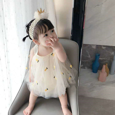 Infant in a Pineapple Frill romper dress, combining comfort and style from Ju Ju Jam