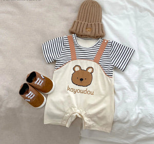 Adorable baby boy wearing a striped dungaree romper with a bear design from Ju Ju Jam