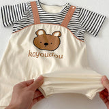 Charming baby boy in a dungaree-style romper with stripes and a bear motif from Ju Ju Jam