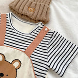 Sweet baby boy dressed in a Striped Bear dungaree romper, designed for comfort and style from Ju Ju Jam.